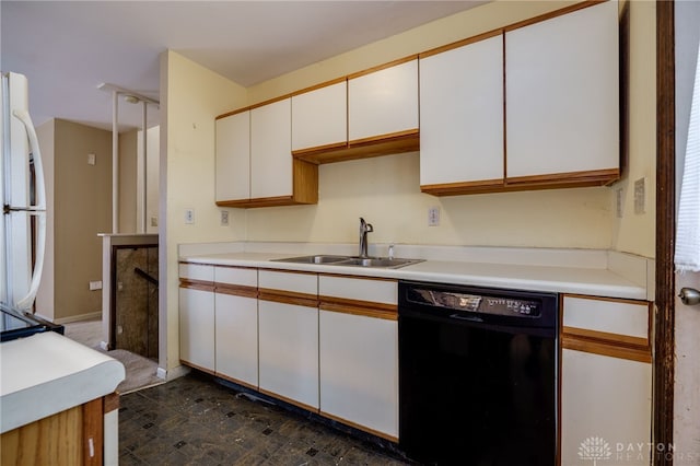 kitchen with dishwasher, white fridge, white cabinetry, and sink