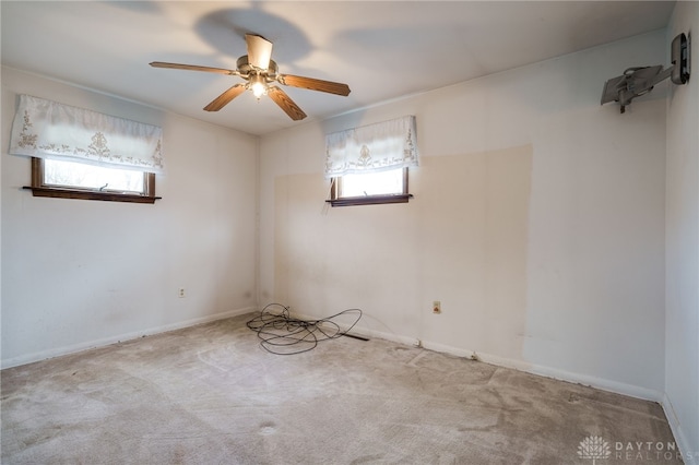 carpeted spare room with ceiling fan