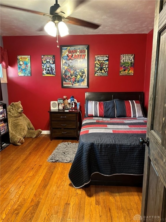 bedroom with ceiling fan and wood-type flooring