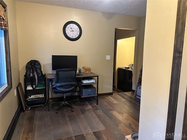 office space with dark wood-type flooring and a textured ceiling