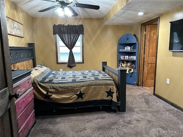 carpeted bedroom featuring a textured ceiling and ceiling fan