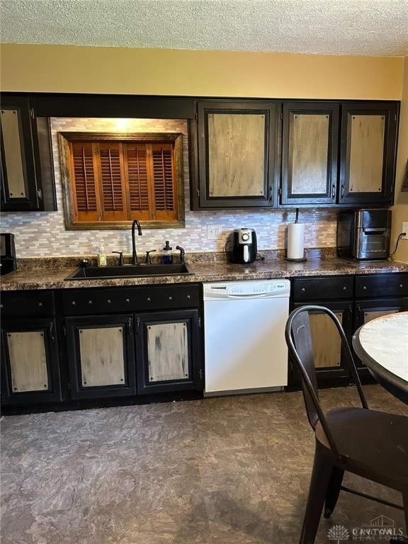 kitchen with tasteful backsplash, sink, white dishwasher, and a textured ceiling