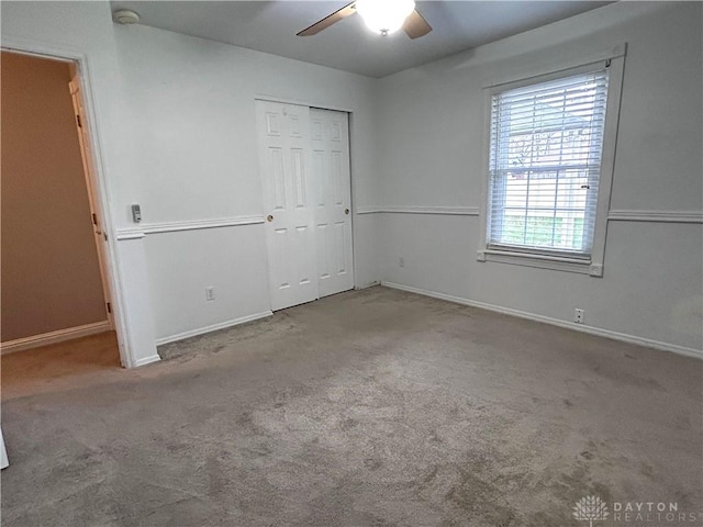 unfurnished bedroom with ceiling fan, a closet, and light colored carpet