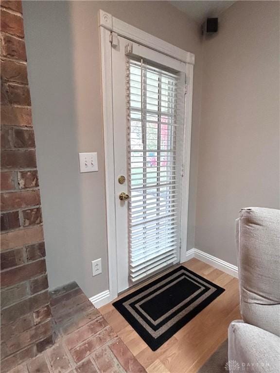 doorway with hardwood / wood-style floors