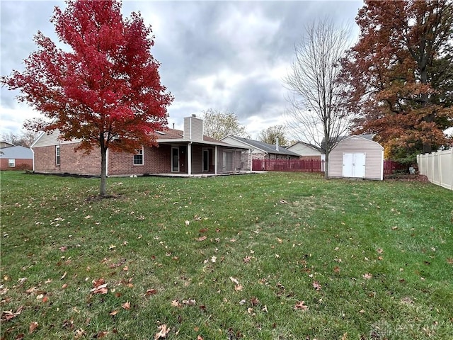 view of yard with a patio area and a storage shed