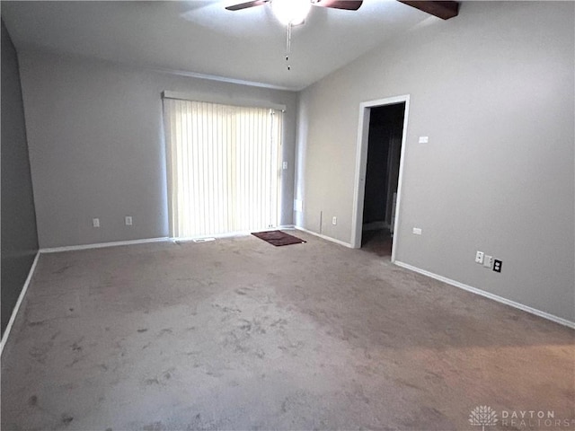 carpeted spare room with ceiling fan and lofted ceiling