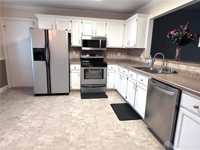 kitchen with backsplash, white cabinets, sink, ornamental molding, and stainless steel appliances