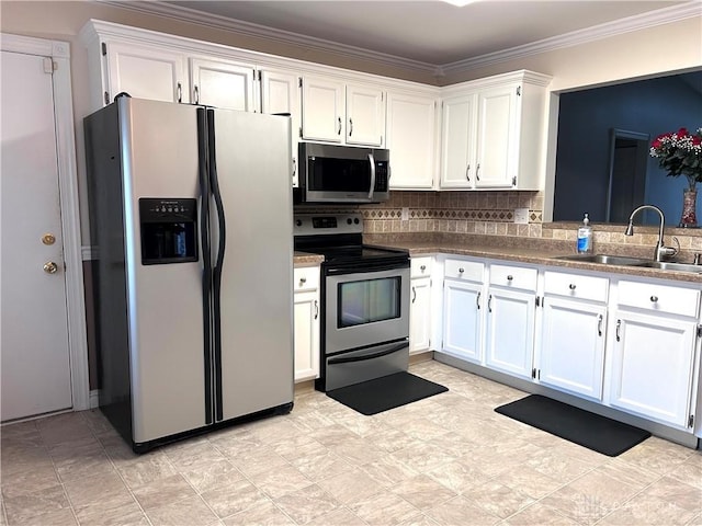 kitchen featuring white cabinets, decorative backsplash, sink, and appliances with stainless steel finishes