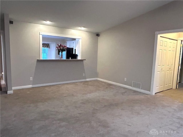 spare room featuring light carpet