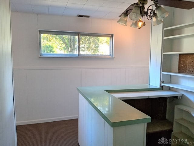 unfurnished office featuring dark carpet and plenty of natural light