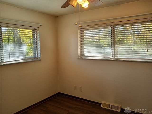 spare room with ceiling fan and dark hardwood / wood-style floors