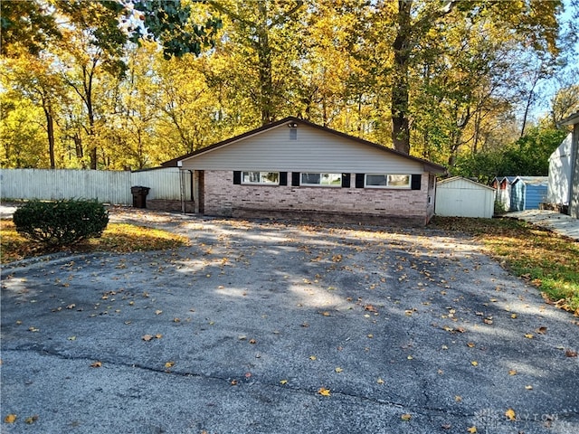 view of home's exterior with a storage shed