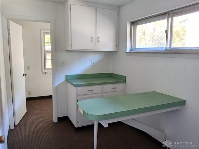 unfurnished office with dark colored carpet