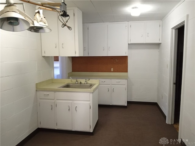 kitchen with white cabinetry and sink