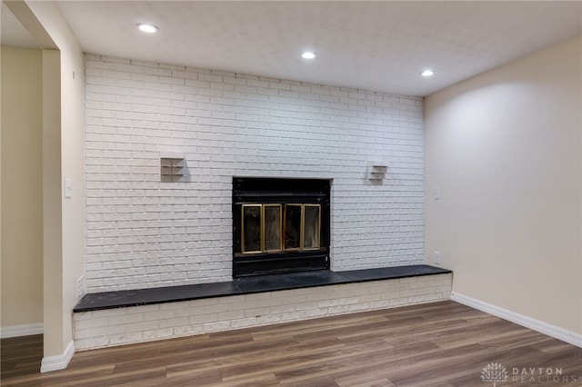 room details with hardwood / wood-style flooring and a brick fireplace