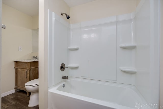 full bathroom with hardwood / wood-style floors, vanity, toilet, and shower / tub combination