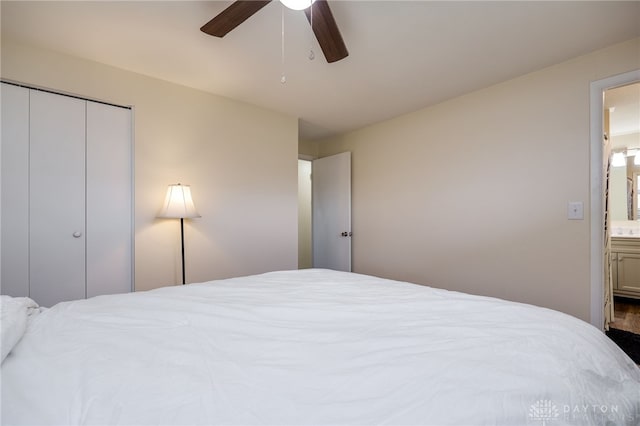 bedroom featuring ensuite bath, ceiling fan, and a closet