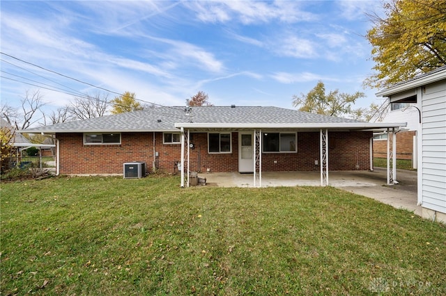 back of house with a patio, a lawn, and central air condition unit