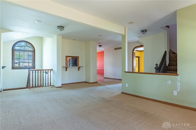 unfurnished room with light carpet