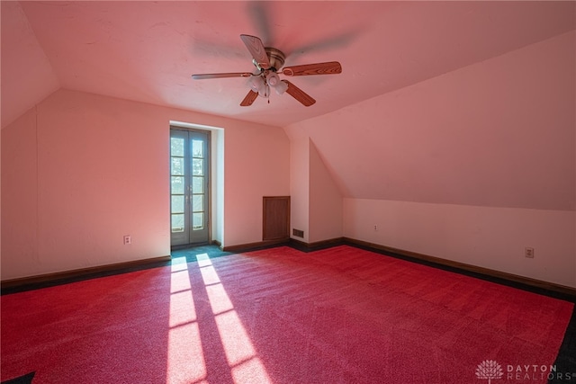 additional living space with carpet, ceiling fan, and vaulted ceiling