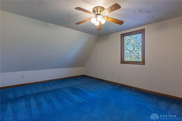 bonus room featuring ceiling fan, lofted ceiling, and dark carpet