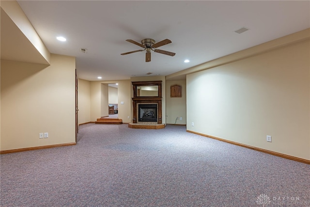 unfurnished living room featuring ceiling fan and carpet floors