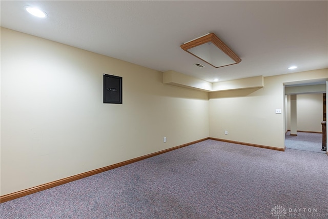 basement featuring electric panel and carpet floors