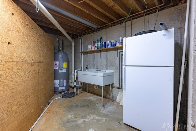 basement with water heater, sink, and white refrigerator