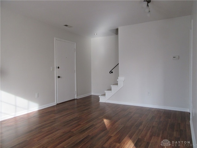 spare room featuring dark hardwood / wood-style floors