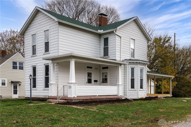 view of front of property with covered porch and a front yard