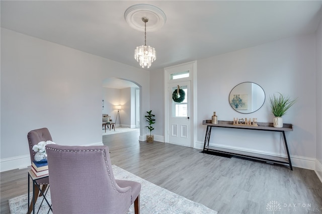 entryway featuring hardwood / wood-style flooring and a chandelier