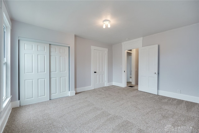 unfurnished bedroom with carpet flooring and a closet