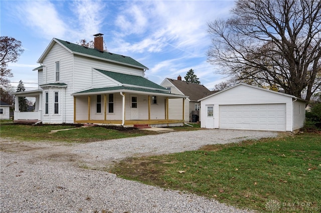 view of front of property with a porch, a garage, an outbuilding, and a front lawn