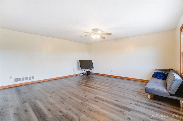 unfurnished room with light wood-type flooring and ceiling fan