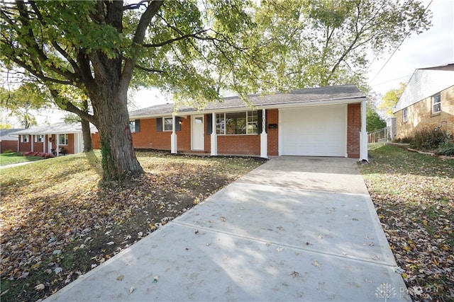 ranch-style house featuring a garage and a front yard