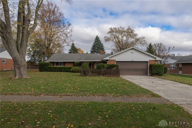 ranch-style home featuring a garage and a front yard