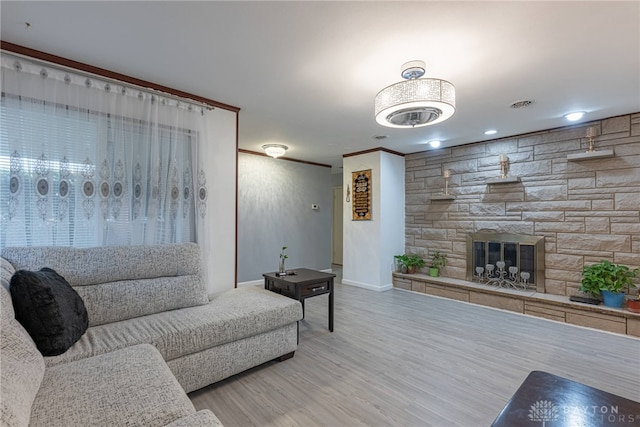 living room with hardwood / wood-style flooring and a fireplace