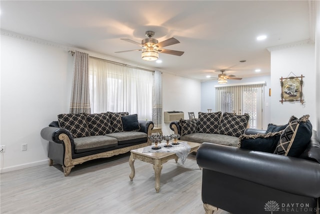 living room with light hardwood / wood-style floors, ceiling fan, plenty of natural light, and a wall mounted air conditioner