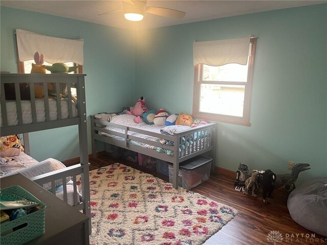 bedroom featuring wood finished floors, ceiling fan, and baseboards