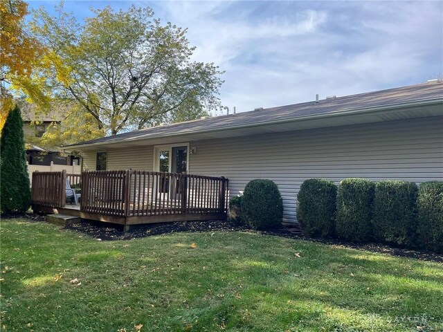 back of house with a yard and a wooden deck