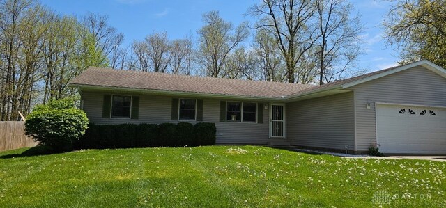 single story home featuring fence, a front yard, and a garage