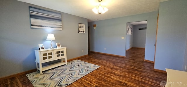 unfurnished room with baseboards and wood finished floors