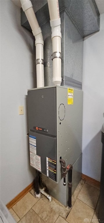 utility room featuring heating unit
