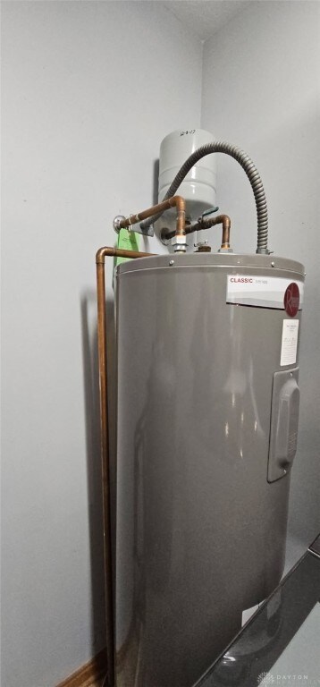 utility room featuring electric water heater
