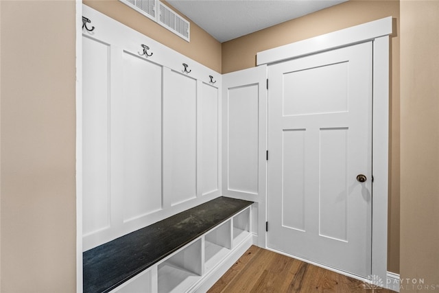 mudroom with light hardwood / wood-style floors