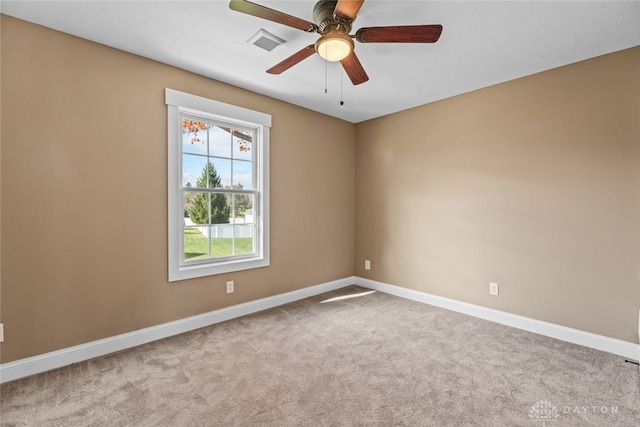 empty room featuring light carpet and ceiling fan