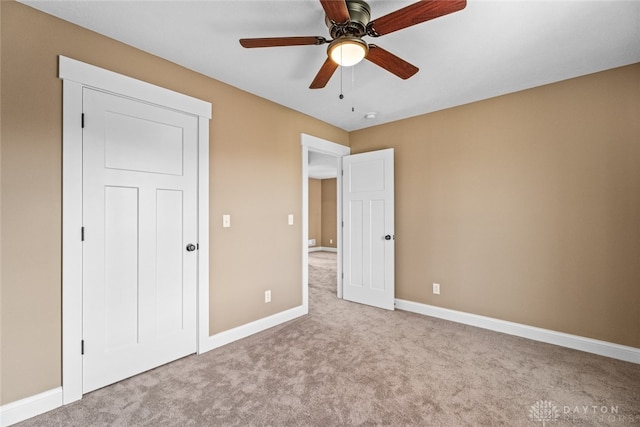 unfurnished bedroom with ceiling fan and light carpet