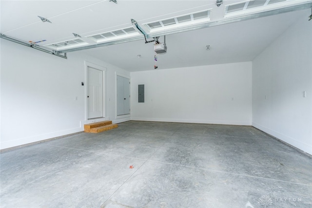 garage with electric panel and a garage door opener