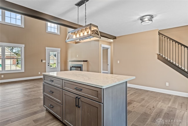 kitchen with a wealth of natural light, light hardwood / wood-style floors, and decorative light fixtures