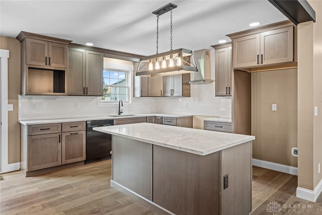 kitchen with dishwasher, decorative light fixtures, light hardwood / wood-style flooring, and sink